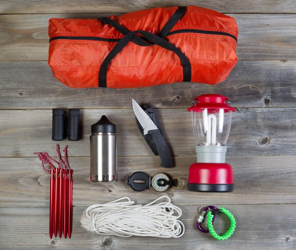 camping accessories on rustic wood