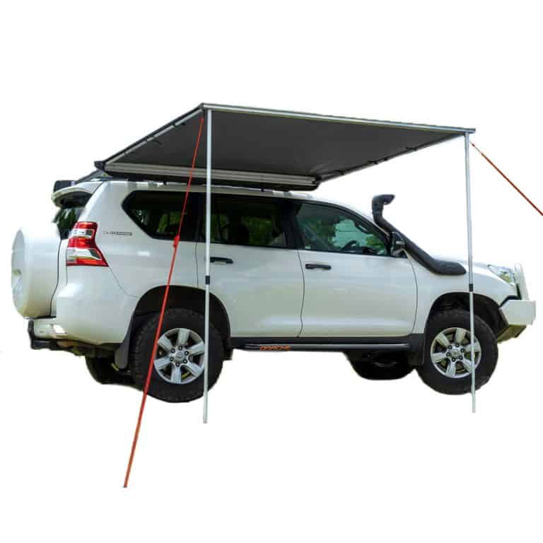 a truck with a rooftop tent and pullout awning.