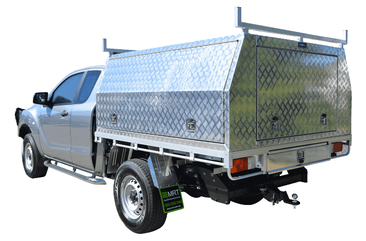 A silver pick up truck with a flat bed equipped with the best canopy trays.