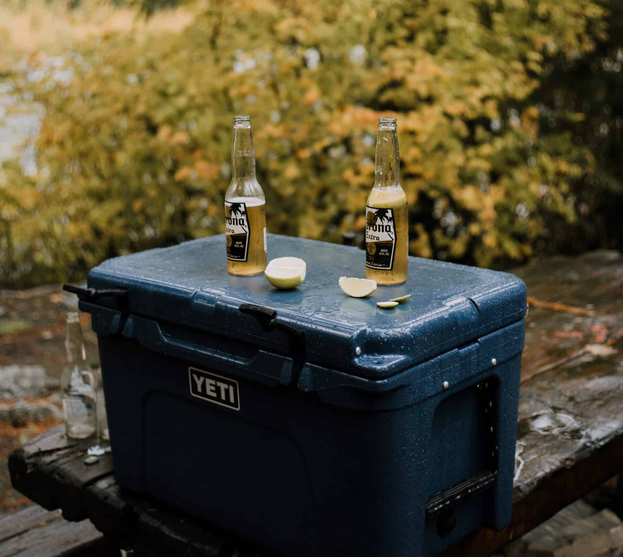 Two bottles of beer sitting on top of an essential camping accessory.