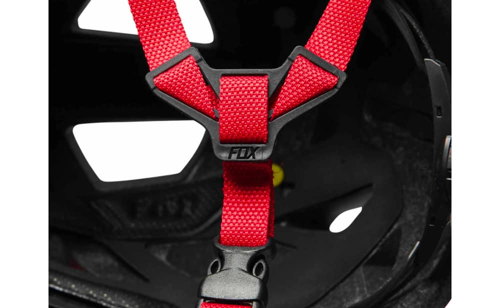 A Bike Accessory helmet with a red seat belt attached to it.